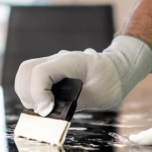 Hand qpplying film on a table