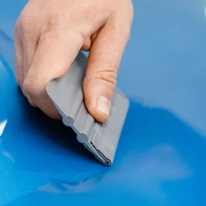 Squeegee applying covering film